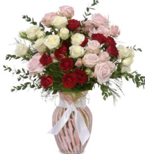 Multiple Spray Rose blooms fill the sugar-sweet pink vase for a romantic and cheerful display. The sweetheart roses offer a delicate display with a traditional color scheme. The soft pink vase compliments the blooms perfectly.