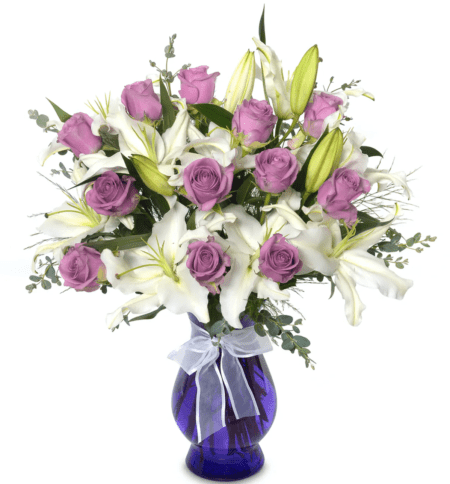 Pure white Lilies surrounded with lush greenery for an elegant display for any occasion. Bring some in lavender roses for a truly special arrangement. The container may vary in color or shape according to availability.