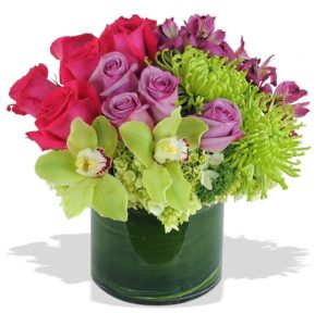 lavender and pink roses with green orchids and mums in vase