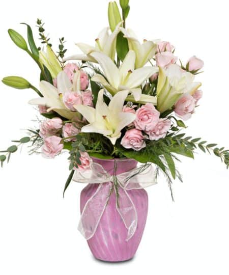 this classic bouquet features Ivory Asiatic Lilies and soft pink Multi-bloom roses. These petite roses fill the arrangement with a sweet elegance